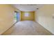 Bright living room with a sliding glass door and neutral wall color at 1249 Abbey Crescent Ln, Clearwater, FL 33759