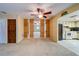 Open living room with a ceiling fan, unique accent wall, and a partial view into the kitchen at 1249 Abbey Crescent Ln, Clearwater, FL 33759