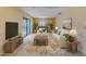 Bright living room with sliding glass door, neutral furniture and a stylish floral rug at 1249 Abbey Crescent Ln, Clearwater, FL 33759
