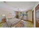 Cozy main bedroom with neutral decor, a window with curtains, and ample natural light at 1249 Abbey Crescent Ln, Clearwater, FL 33759