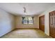 Main bedroom featuring a ceiling fan, window with curtains and ample closet space at 1249 Abbey Crescent Ln, Clearwater, FL 33759