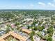 Expansive aerial view of a community featuring lush green landscapes, various residences and community pool at 12760 Indian Rocks Rd # 410, Largo, FL 33774
