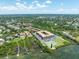 Waterfront living featuring a tennis court, private dock, and lush landscaping at 12760 Indian Rocks Rd # 410, Largo, FL 33774