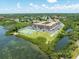 Waterfront building with scenic views, tennis court, and lush landscaping at 12760 Indian Rocks Rd # 410, Largo, FL 33774