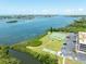 Waterfront complex featuring a tennis court, shuffleboard, and scenic water views at 12760 Indian Rocks Rd # 410, Largo, FL 33774