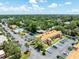 An aerial view of the condo complex featuring lush landscaping, parking, a pool, and well-maintained buildings at 12760 Indian Rocks Rd # 410, Largo, FL 33774