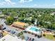 Aerial view of community pool and lounge chairs with lush landscaping at 12760 Indian Rocks Rd # 410, Largo, FL 33774
