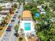Aerial view of community pool with lounge chairs surrounded by palms and well manicured landscaping at 12760 Indian Rocks Rd # 410, Largo, FL 33774