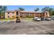 A multi-story apartment building with balconies, well-maintained landscaping, and a parking lot for residents at 12760 Indian Rocks Rd # 410, Largo, FL 33774