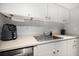Well-equipped kitchen with white cabinets, subway tile backsplash, and modern appliances at 12760 Indian Rocks Rd # 410, Largo, FL 33774