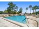 Large community swimming pool with lounge chairs and palm trees offering a relaxing and luxurious outdoor space at 12760 Indian Rocks Rd # 410, Largo, FL 33774