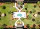Aerial view of an inviting outdoor pool area surrounded by lush landscaping at 12760 Indian Rocks Rd # 410, Largo, FL 33774