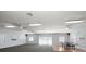 Spacious recreation room filled with natural light, ceiling fans, a ping pong table and access to the outside at 12760 Indian Rocks Rd # 410, Largo, FL 33774