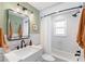The bathroom has a shower, a white sink, and modern, sleek fixtures and lighting at 1408 Michigan Ave, Palm Harbor, FL 34683