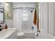 This bathroom offers a shower with a tub, green accents, and classic subway tile at 1408 Michigan Ave, Palm Harbor, FL 34683