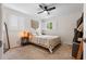 This bedroom features a ceiling fan and dual shuttered windows, and is well lit at 1408 Michigan Ave, Palm Harbor, FL 34683