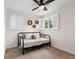 This bedroom features a ceiling fan, a neutral palette, and hexagon wall shelves at 1408 Michigan Ave, Palm Harbor, FL 34683