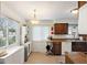 Efficient kitchen layout with ample storage and natural light from a large window at 1408 Michigan Ave, Palm Harbor, FL 34683
