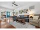 Open living space with hardwood floors, a blue couch, and a blue entry door at 1408 Michigan Ave, Palm Harbor, FL 34683