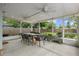 Covered outdoor patio with fans, perfect for dining and enjoying a beautiful, fenced backyard at 1408 Michigan Ave, Palm Harbor, FL 34683