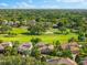 Community aerial showcasing lush landscaping and the meticulously maintained golf course at 1416 Via Verdi Dr, Palm Harbor, FL 34683