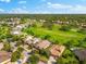 Gorgeous aerial view of a neighborhood, landscaping, and nearby golf course at 1416 Via Verdi Dr, Palm Harbor, FL 34683