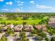 Aerial view of upscale homes and golf course in lush, green community at 1416 Via Verdi Dr, Palm Harbor, FL 34683