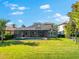 The backyard has an extensive screened patio with a pool and well-maintained lawn at 1416 Via Verdi Dr, Palm Harbor, FL 34683