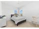 Cozy bedroom with a queen bed, plush carpeting, and natural light, providing a comfortable and inviting atmosphere at 1416 Via Verdi Dr, Palm Harbor, FL 34683