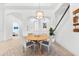 Bright dining area features a round table, four chairs, elegant light fixture, and stylish decor at 1416 Via Verdi Dr, Palm Harbor, FL 34683