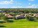 Stunning view of the backyard and landscaping from the community green space at 1416 Via Verdi Dr, Palm Harbor, FL 34683