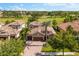 Beautiful home showcasing a tile roof, brick driveway, and lush landscaping with a golf course in the background at 1416 Via Verdi Dr, Palm Harbor, FL 34683
