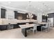 Spacious kitchen featuring sleek dark cabinetry, a large island with seating, and ample countertop space at 1416 Via Verdi Dr, Palm Harbor, FL 34683