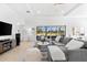 Bright living room featuring a large sectional sofa, stylish decor, and expansive views of the outdoor scenery at 1416 Via Verdi Dr, Palm Harbor, FL 34683