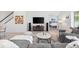 Cozy living room with a large television, modern entertainment unit, and comfortable seating arrangement at 1416 Via Verdi Dr, Palm Harbor, FL 34683