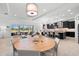 Open-concept living space with modern furniture, dining area, and a kitchen with dark cabinetry at 1416 Via Verdi Dr, Palm Harbor, FL 34683