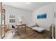 Bright office space featuring natural light, a wooden desk, a comfortable sofa, and light hardwood floors at 1416 Via Verdi Dr, Palm Harbor, FL 34683