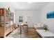 Bright office space featuring natural light, a wooden desk, a comfortable sofa, and light hardwood floors at 1416 Via Verdi Dr, Palm Harbor, FL 34683