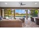 Screened-in patio featuring comfortable wicker seating and an open view of the backyard pool area at 1416 Via Verdi Dr, Palm Harbor, FL 34683
