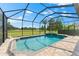 The backyard features a screened pool, a spa, and an expansive golf course view at 1416 Via Verdi Dr, Palm Harbor, FL 34683