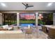 Covered outdoor patio features an in-ground pool with serene views of the golf course at 1416 Via Verdi Dr, Palm Harbor, FL 34683