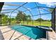 Sparkling pool with attached spa overlooks the golf course through a screened-in lanai, offering outdoor enjoyment at 1416 Via Verdi Dr, Palm Harbor, FL 34683
