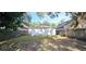 View of the backyard showing the fence line, back of house and mature trees with Spanish moss at 15124 Deer Meadow Dr, Lutz, FL 33559