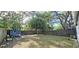 Large fenced backyard featuring mature trees and a storage shed, perfect for outdoor activities and relaxation at 15124 Deer Meadow Dr, Lutz, FL 33559