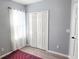 Bright bedroom with wood floors, featuring a built-in closet and a sunlit window with sheer curtains at 15124 Deer Meadow Dr, Lutz, FL 33559