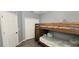 ' bedroom with a wooden bunk bed and a closet, featuring light gray walls and laminate flooring at 15124 Deer Meadow Dr, Lutz, FL 33559