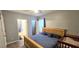Comfortable bedroom with a wood-framed bed, view to en suite bathroom, and ample natural light at 15124 Deer Meadow Dr, Lutz, FL 33559