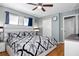 Spacious bedroom with a large window, ceiling fan, and a comfortable bed, providing a relaxing retreat at 1603 Fluorshire Dr, Brandon, FL 33511