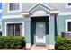 Welcoming front entrance with a covered porch, security screen door, and neat landscaping at 1603 Fluorshire Dr, Brandon, FL 33511