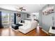 Bright living room with hardwood floors, a ceiling fan, and natural light from large windows at 1603 Fluorshire Dr, Brandon, FL 33511